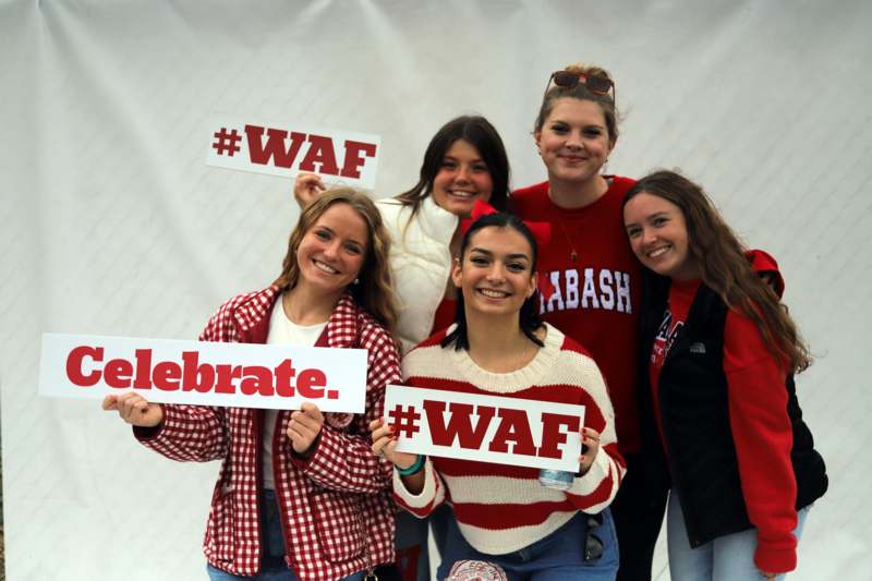 a group of women holding signs