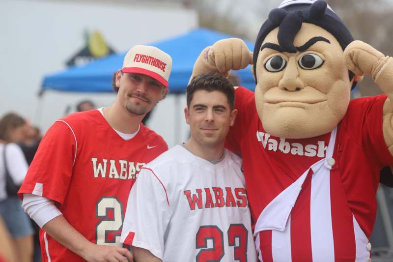 a group of men posing with a mascot