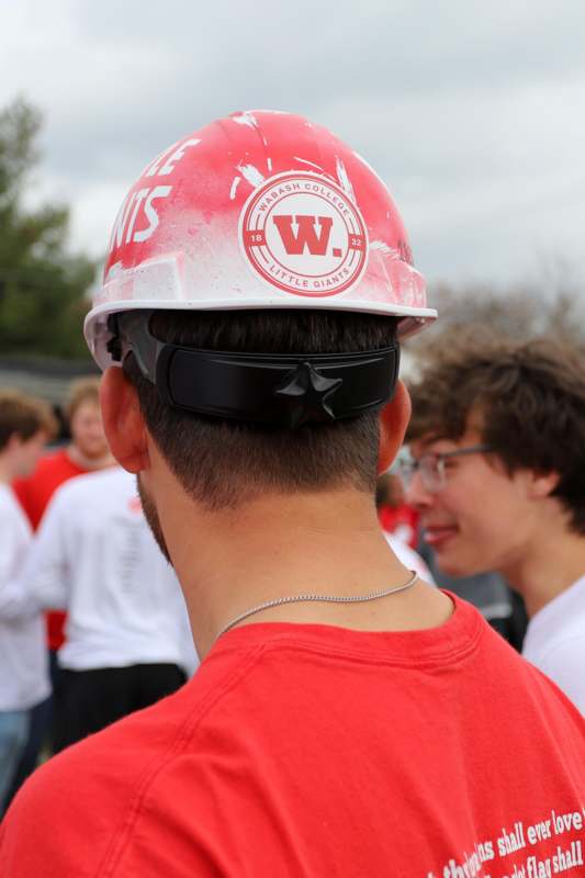 a man wearing a red hard hat