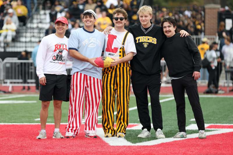 a group of men standing on a football field
