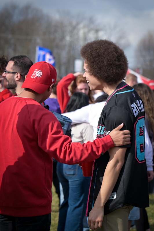 a man holding another man's shoulder