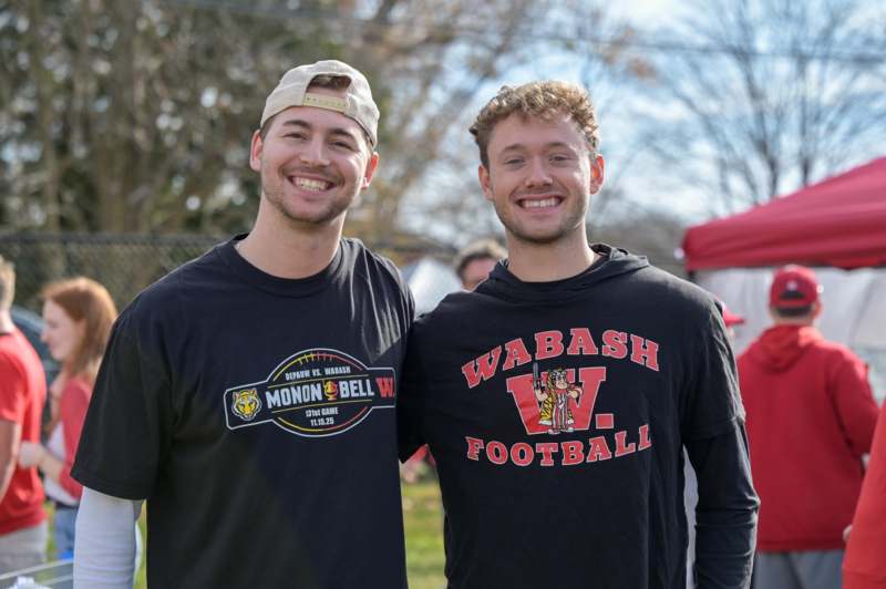 two men smiling at the camera