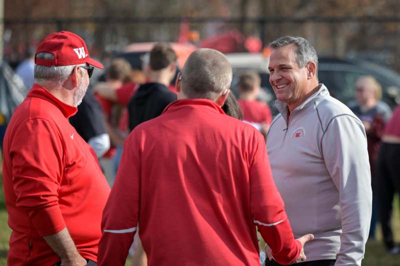 a group of men in red shirts