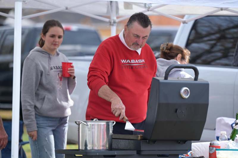 a man cooking food on a grill