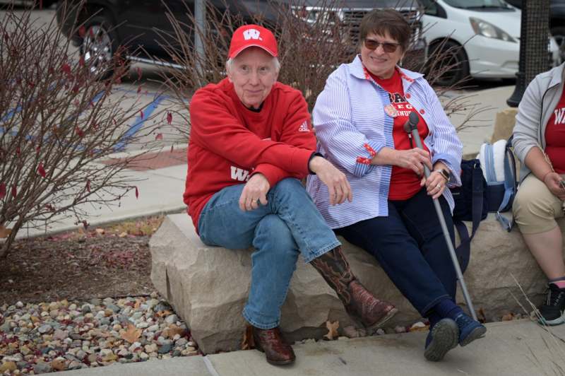 two people sitting on a rock