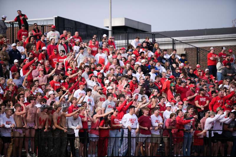 a large crowd of people in red shirts