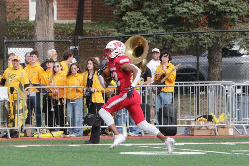 a football player running on a field with a trumpet