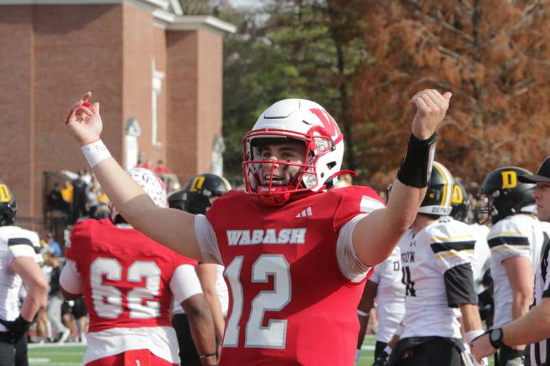 a football player with his arms up