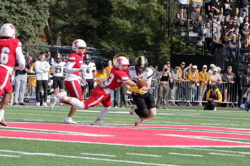 a football player running with a football in the air