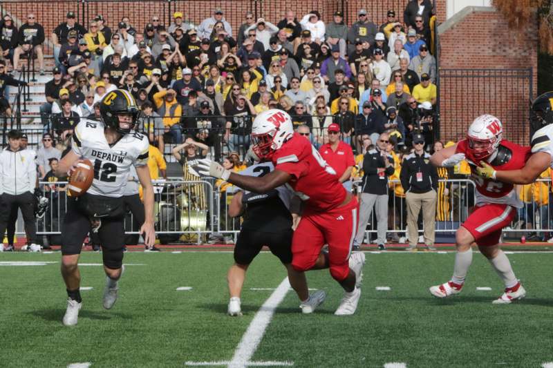 a football player running with the ball in the air