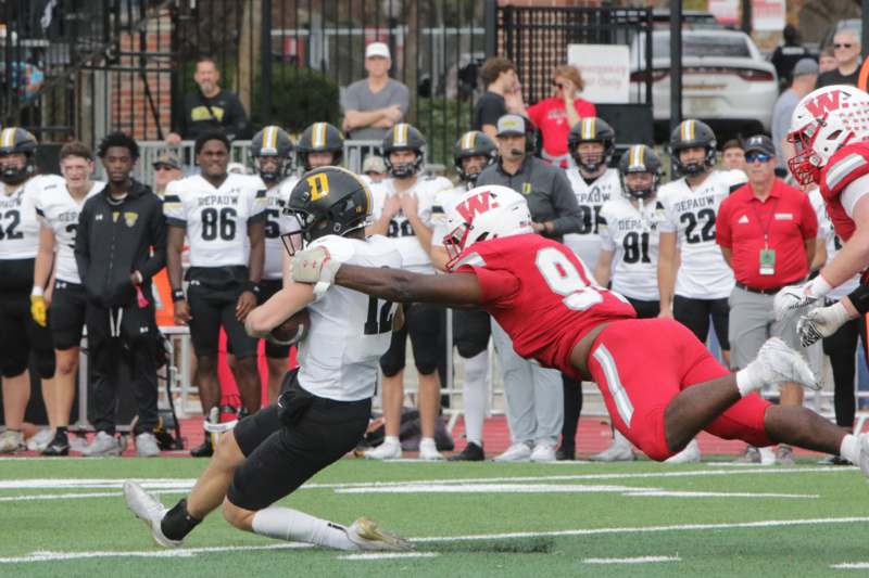 a football player diving for a ball