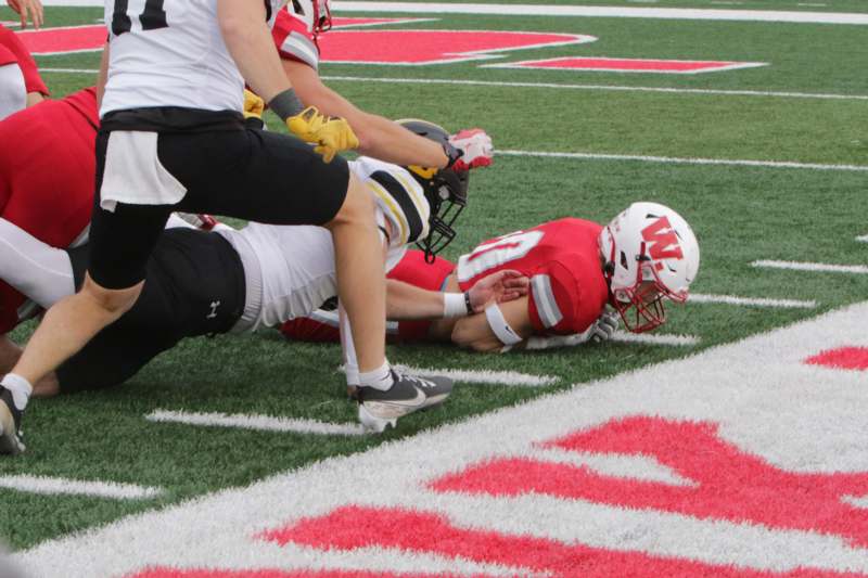 a football player falling down on the field