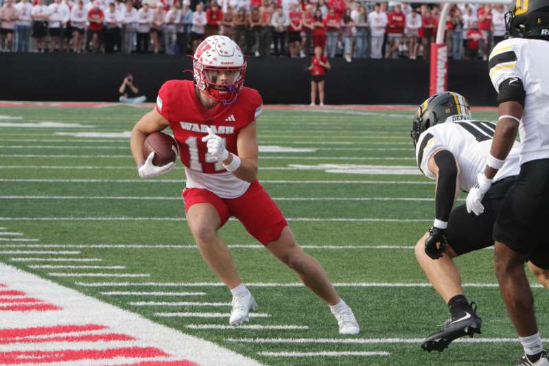 a football player running with a football in his hand