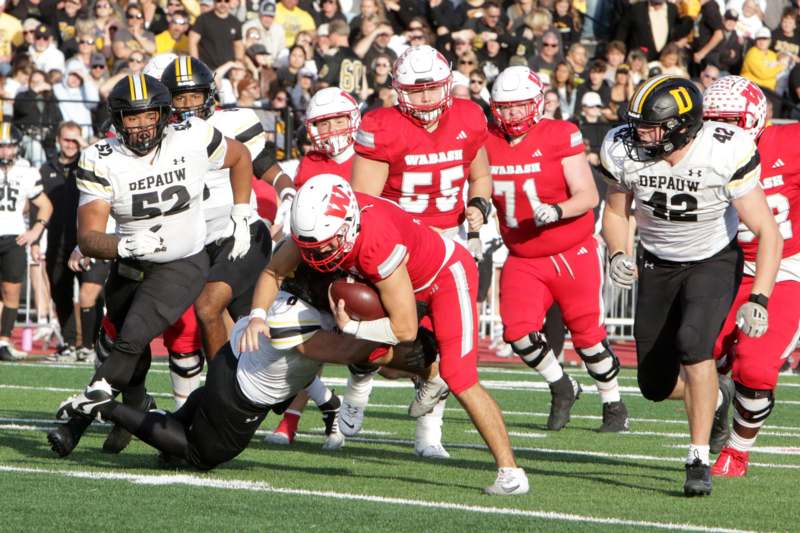 a football player being tackled by other players