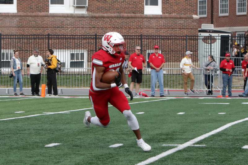 a football player running with a football