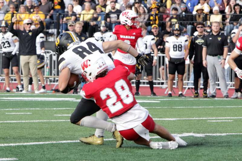 a football player in a red uniform with a football player in the back