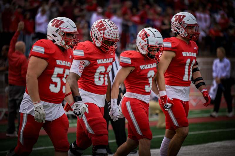 a group of football players walking on a field