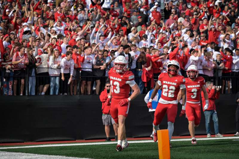 a group of football players running on a field