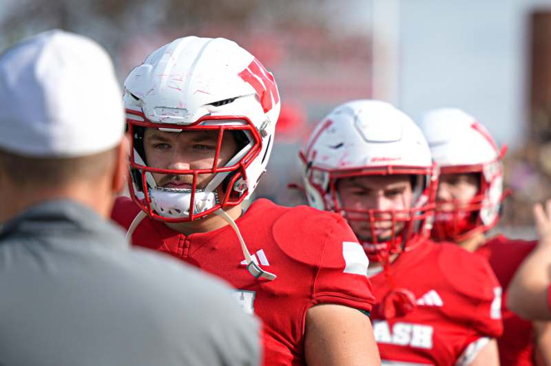a group of football players in red and white uniforms