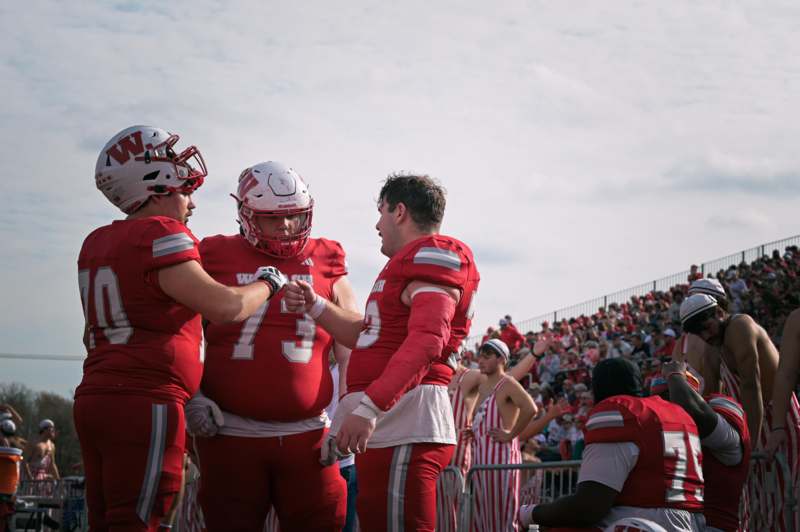 a group of football players in red uniforms