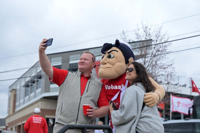 a man taking a selfie with a mascot