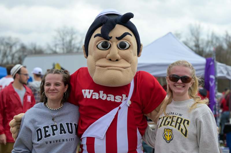 a group of women posing with a mascot