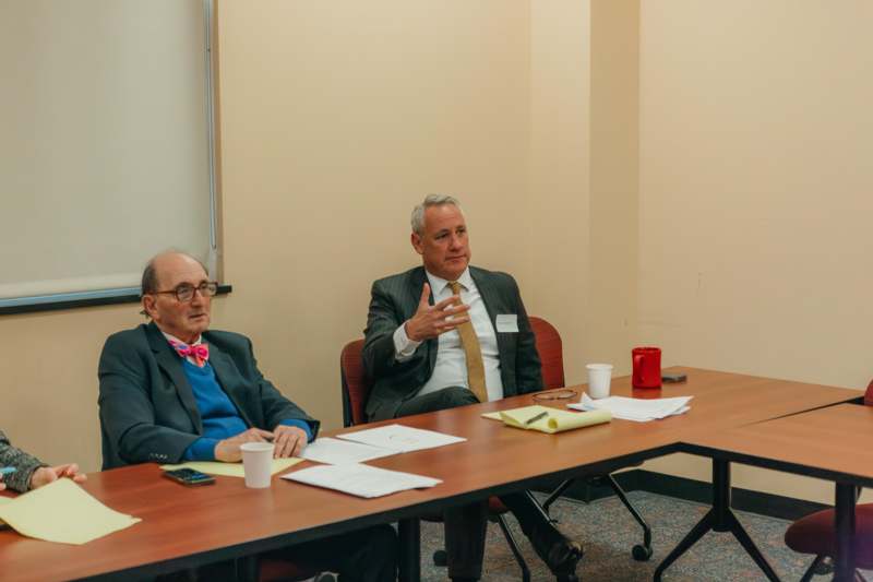 a group of men sitting at a table