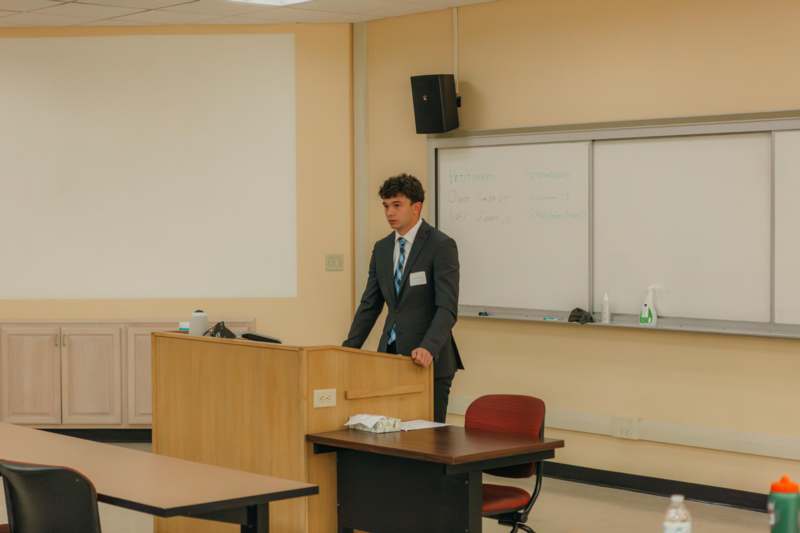 a man standing behind a podium