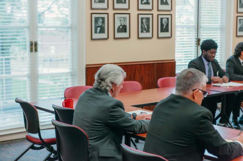 a group of men sitting at a table