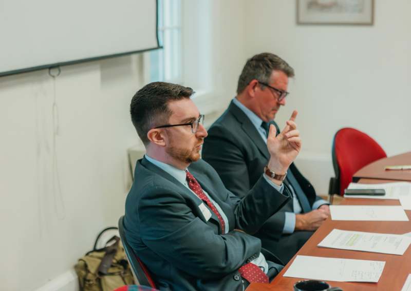 a group of men sitting at a table