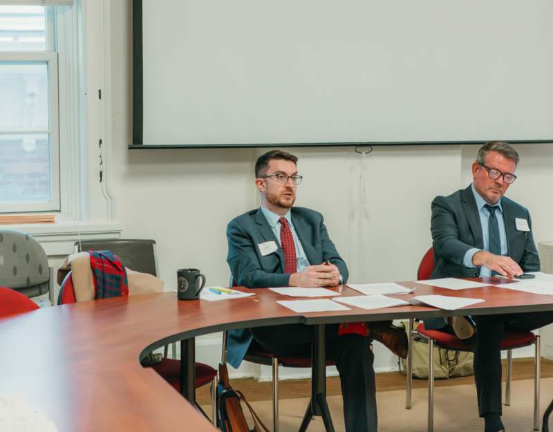 a group of men sitting at a table