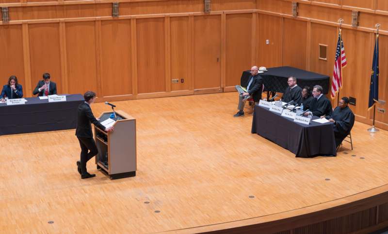 a man standing at a podium with a microphone