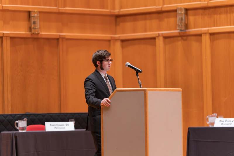 a man standing at a podium with a microphone