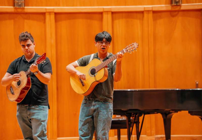 a group of men playing guitars
