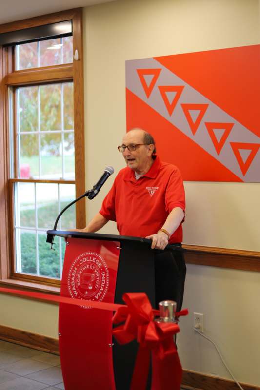 a man standing at a podium with a microphone