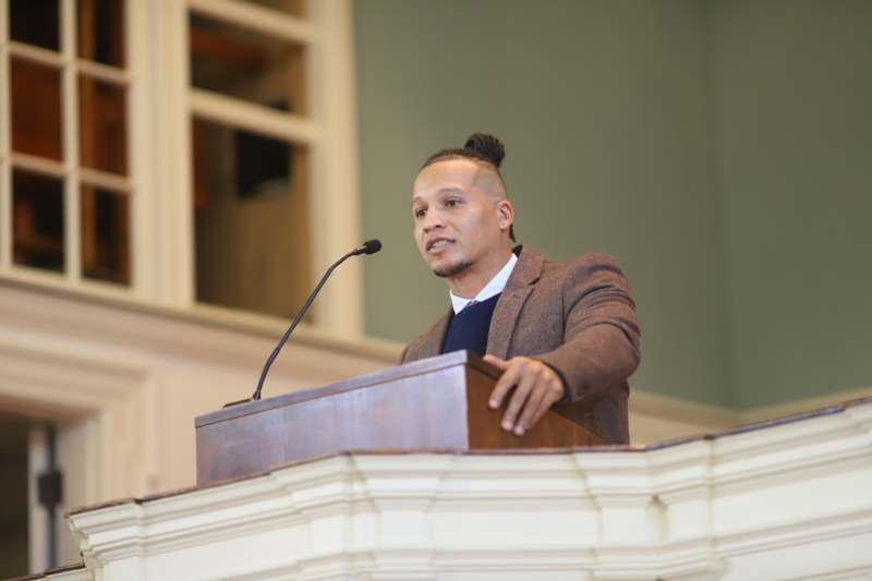 a man standing at a podium with a microphone