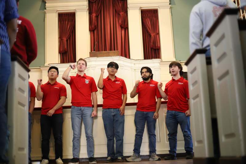 a group of men in red shirts