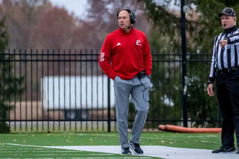 a man wearing headphones and standing on a field