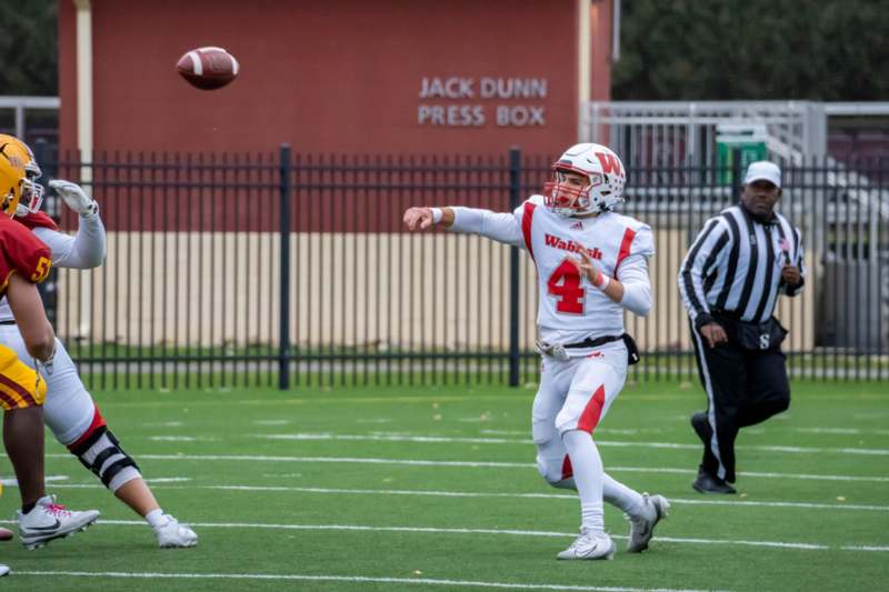 a football player throwing a football