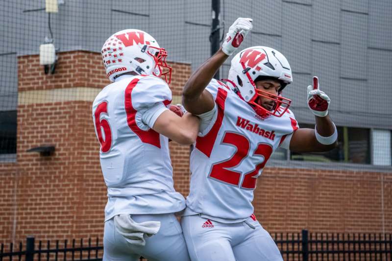 two football players in white and red uniforms