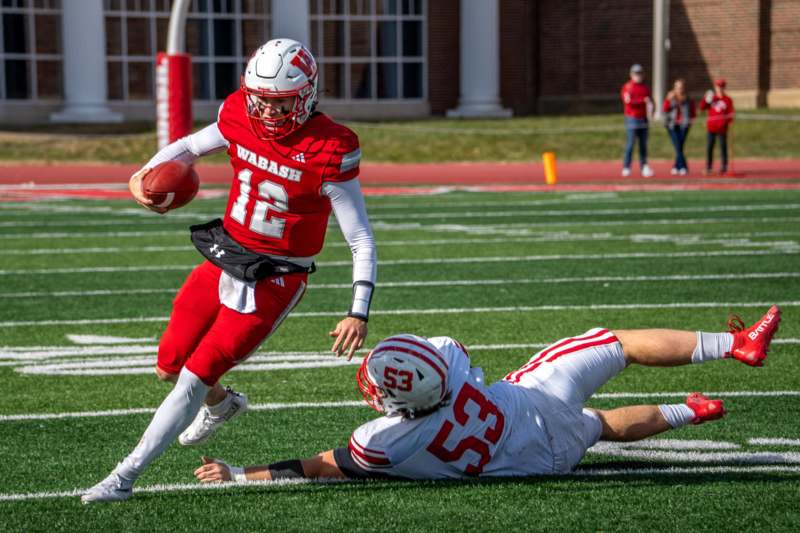 a football player in a red uniform running with a football