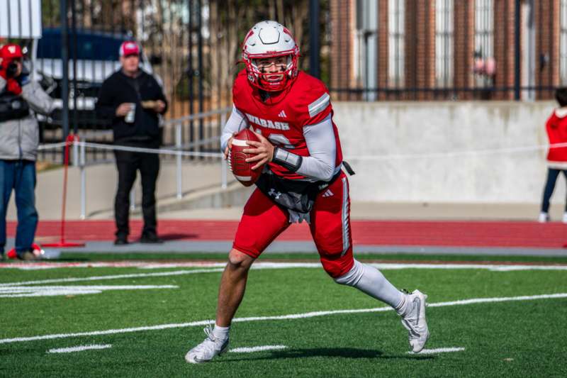 a man in a football uniform holding a football