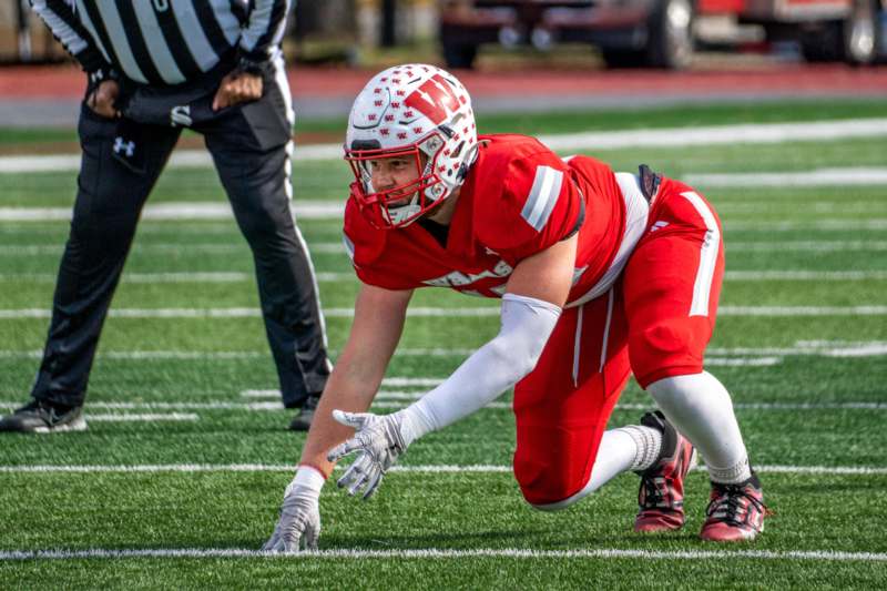 a football player in a red uniform on a field