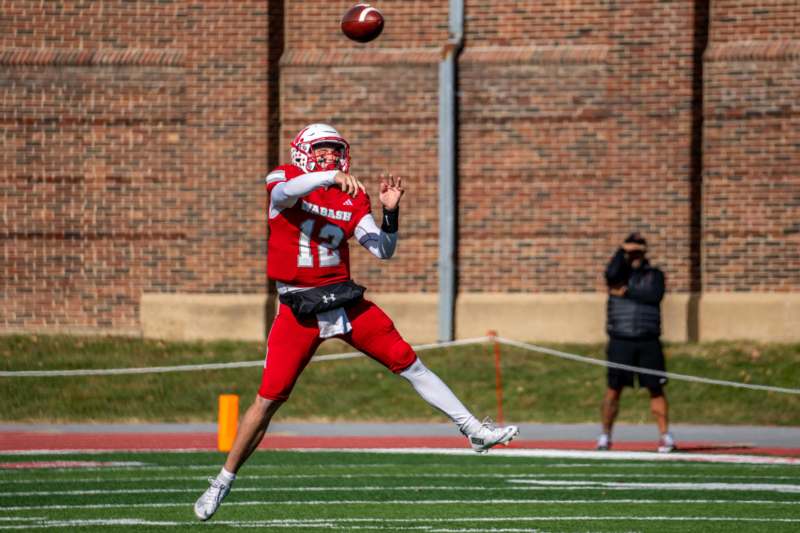 a football player in a uniform catching a football