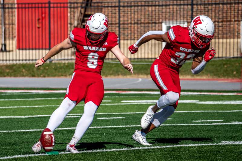 two football players running on a field