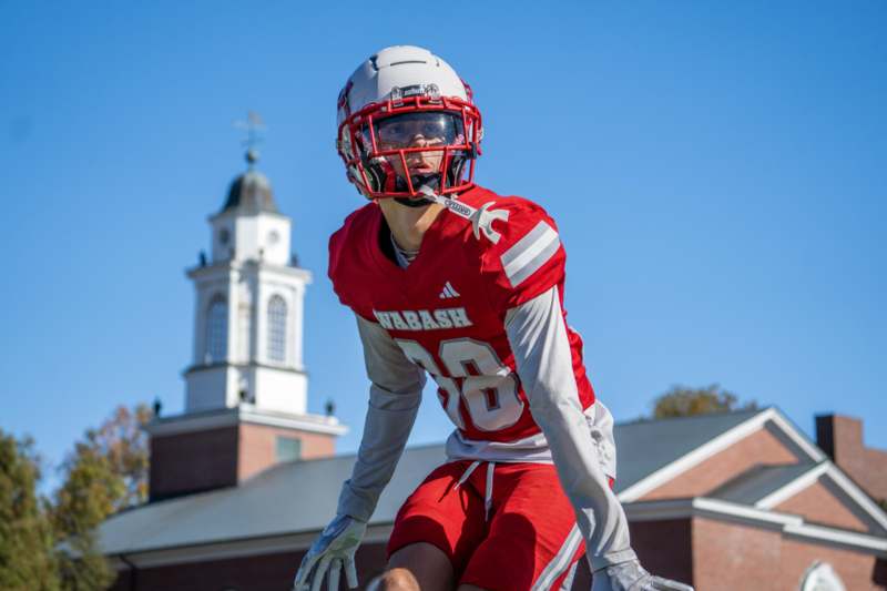 a football player wearing a red uniform and helmet