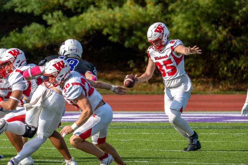 a football player in a uniform with a football in the back