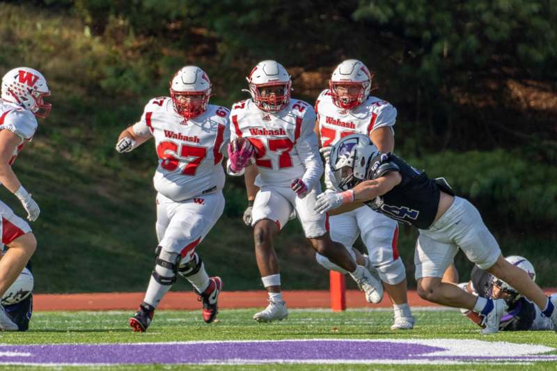 a group of football players running on a field