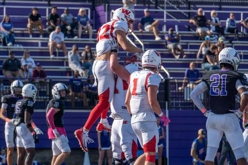 a group of football players in the air