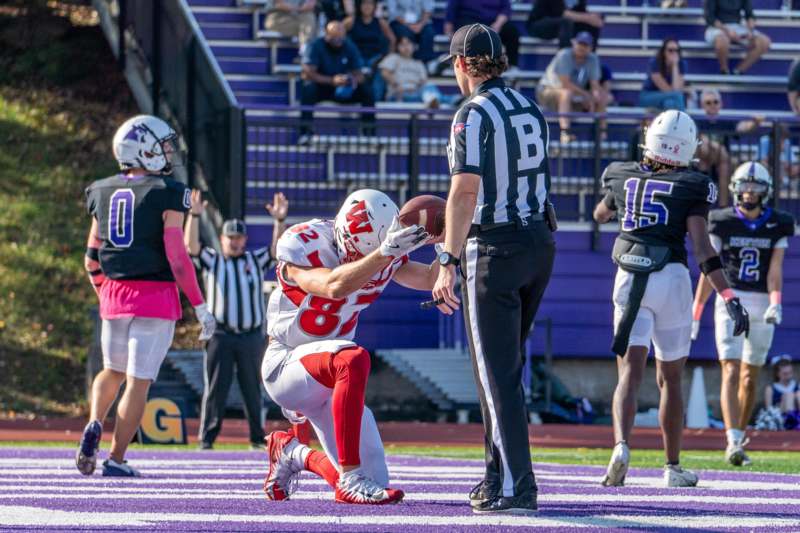 a football player holding a football